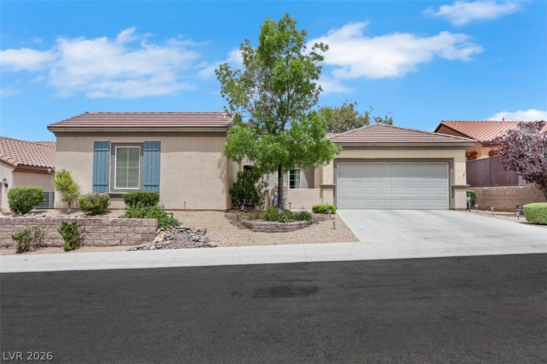 2408 Black River Falls Drive, Henderson, NV 89044 This charming home features a well-maintained exterior with attractive landscaping and an attached garage.