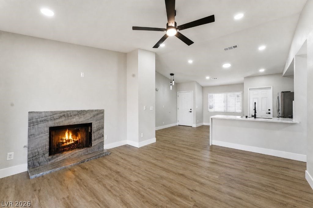 529 Close Avenue, Henderson, NV 89011 This inviting living area boasts a modern fireplace and durable flooring, perfect for comfortable gatherings.