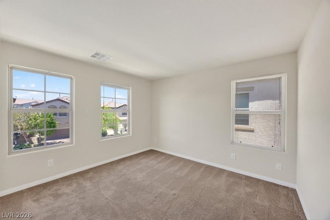 1116 Strada Cristallo, Henderson, NV 89011 Natural light filters into this well-appointed room, providing a serene residential outlook.