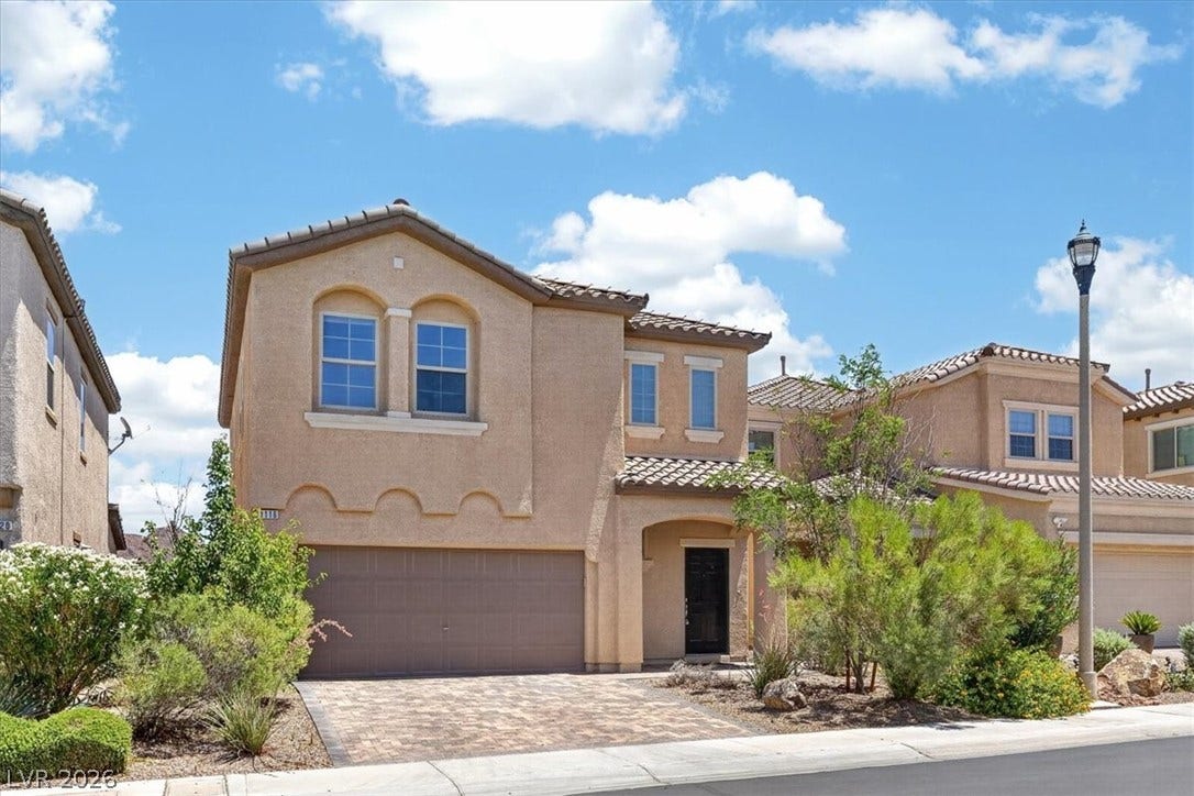 1116 Strada Cristallo, Henderson, NV 89011 A terracotta-tiled roof and paved driveway adorn this inviting residence.