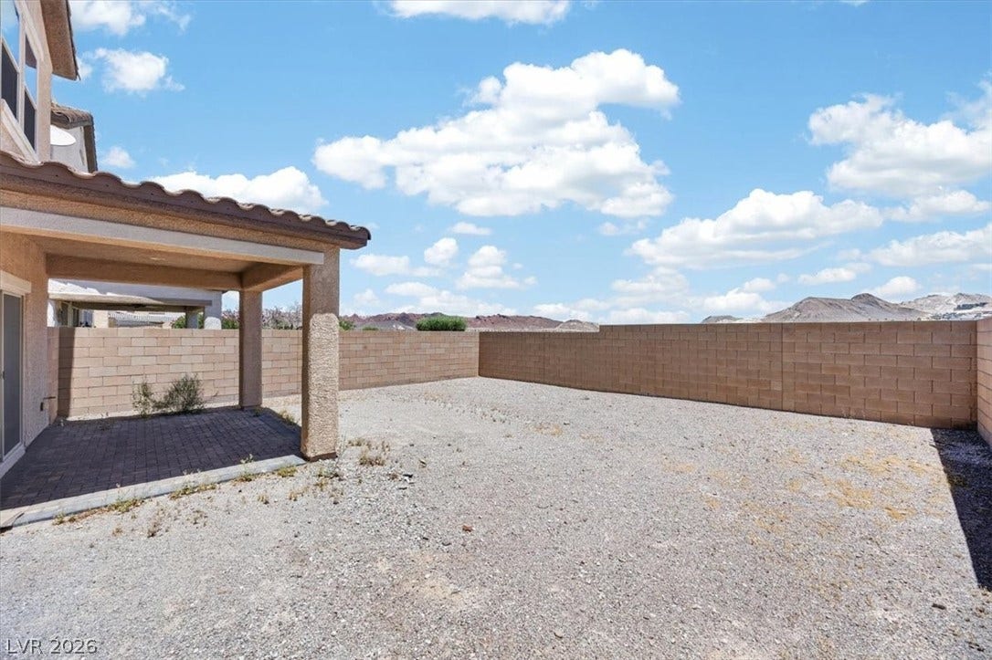1116 Strada Cristallo, Henderson, NV 89011 A covered patio offers shade in this private backyard, with a mountain backdrop.
