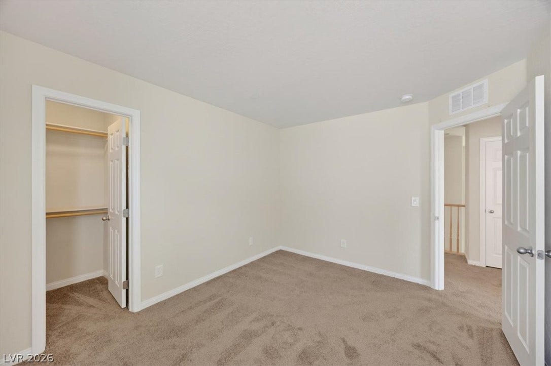 1116 Strada Cristallo, Henderson, NV 89011 A well-lit bedroom awaits, featuring plush carpet flooring and convenient closet access.
