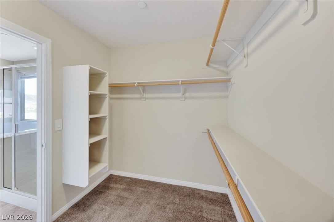 1116 Strada Cristallo, Henderson, NV 89011 Ample shelving and hanging rods maximize storage within this well-appointed closet space.