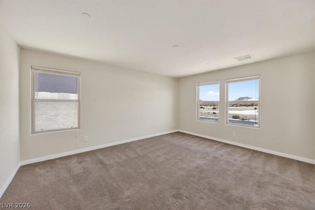 1116 Strada Cristallo, Henderson, NV 89011 A quiet space with soft carpeting and multiple windows offering wide-ranging views.