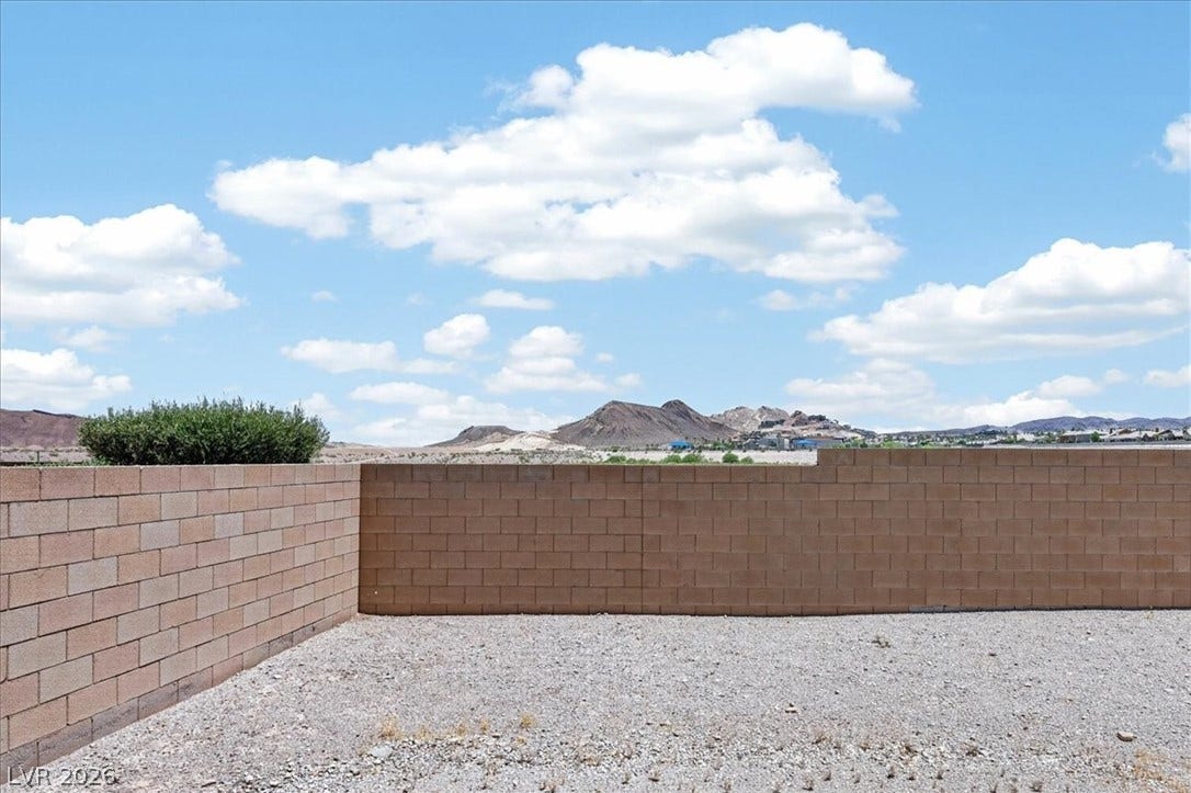 1116 Strada Cristallo, Henderson, NV 89011 Gravel backyard with a sturdy block wall offers sweeping mountain and sky views.