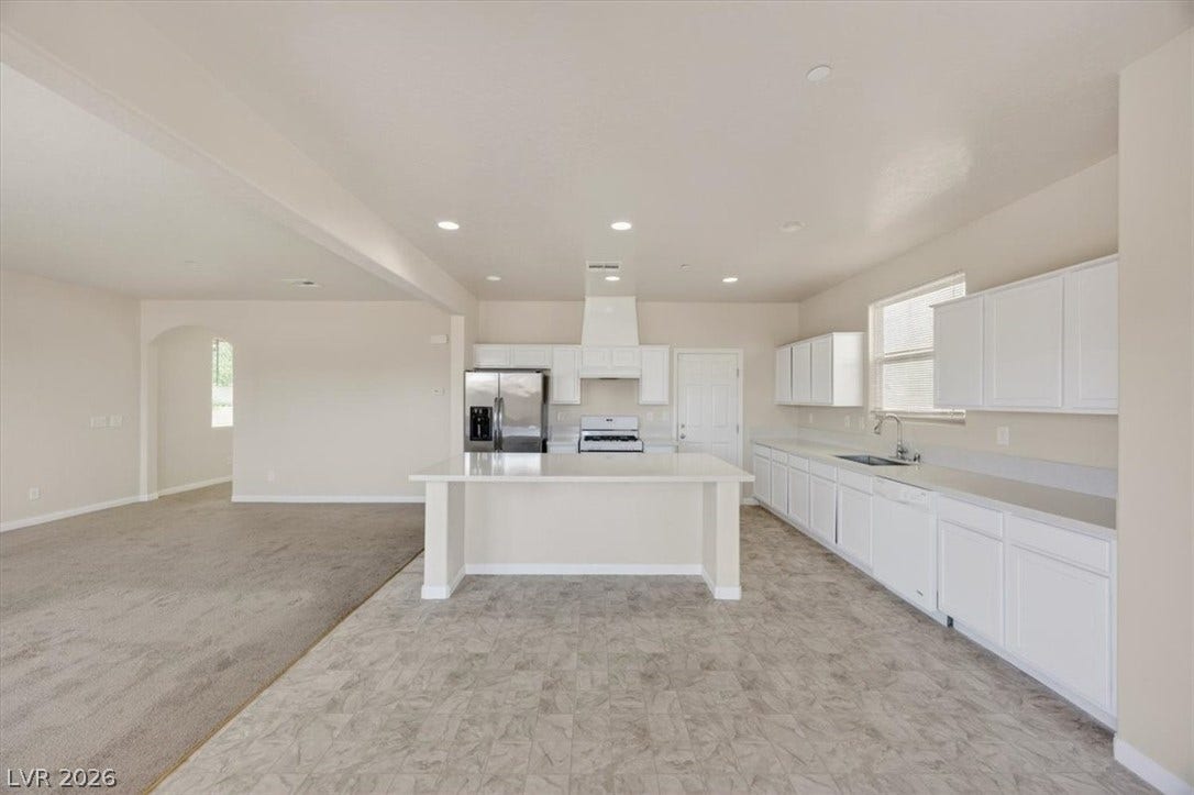 1116 Strada Cristallo, Henderson, NV 89011 A well-appointed kitchen showcasing an island and stainless steel appliances, perfect for culinary endeavors.