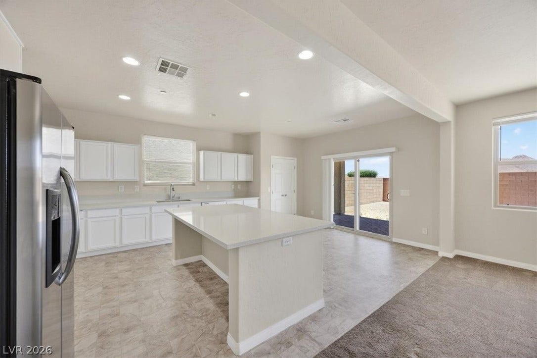 1116 Strada Cristallo, Henderson, NV 89011 A well-appointed kitchen features a central island, recessed lighting, and seamless access to outdoor living.