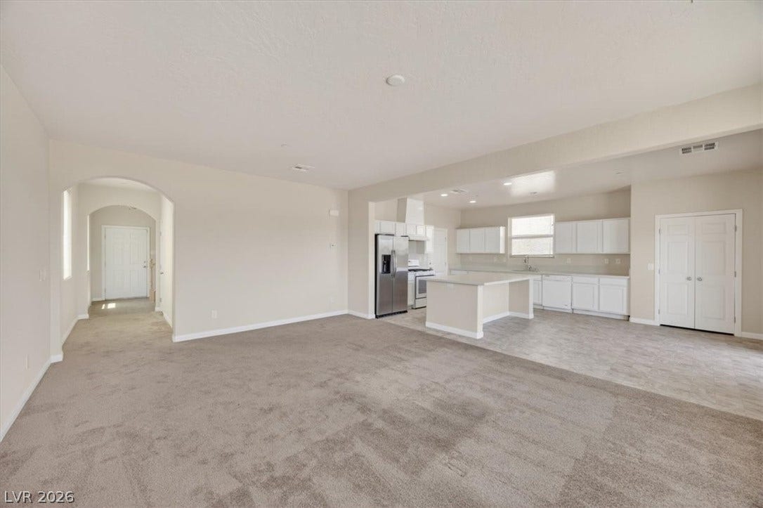 1116 Strada Cristallo, Henderson, NV 89011 An open-concept layout connects a well-lit living area to a streamlined kitchen with an island.