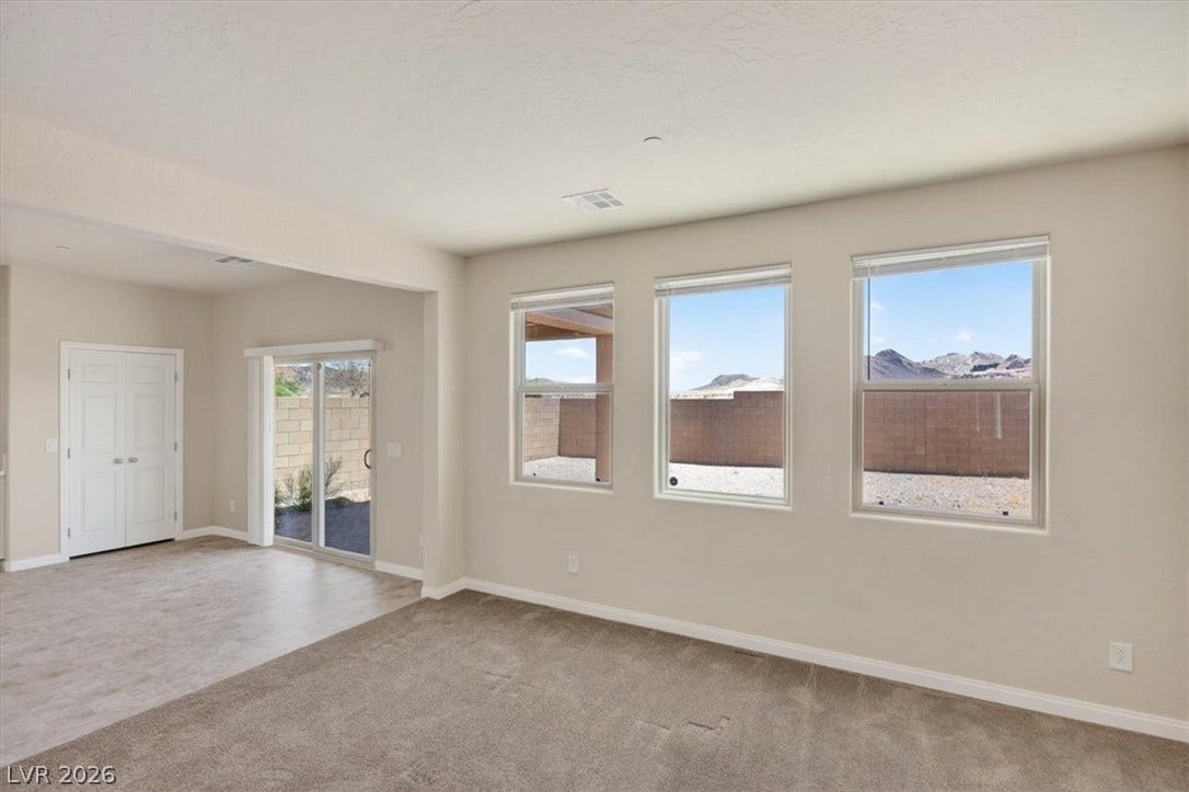 1116 Strada Cristallo, Henderson, NV 89011 Natural light floods this living area, offering clear mountain views.