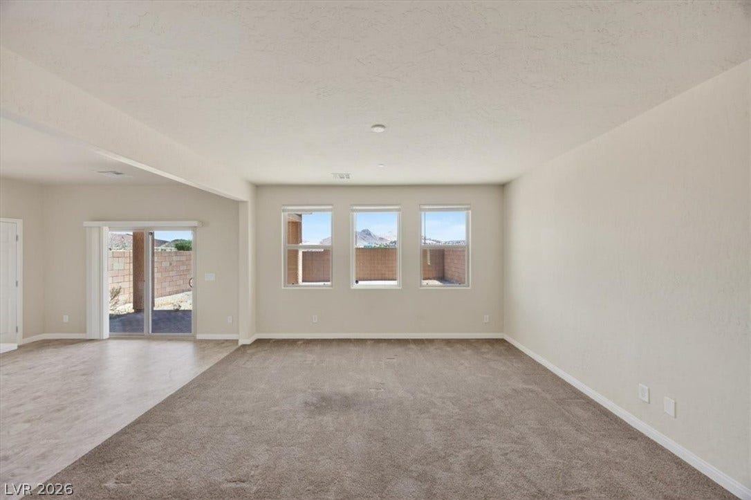 1116 Strada Cristallo, Henderson, NV 89011 A spacious, open-concept living area with abundant natural light from multiple windows and sliding glass doors.