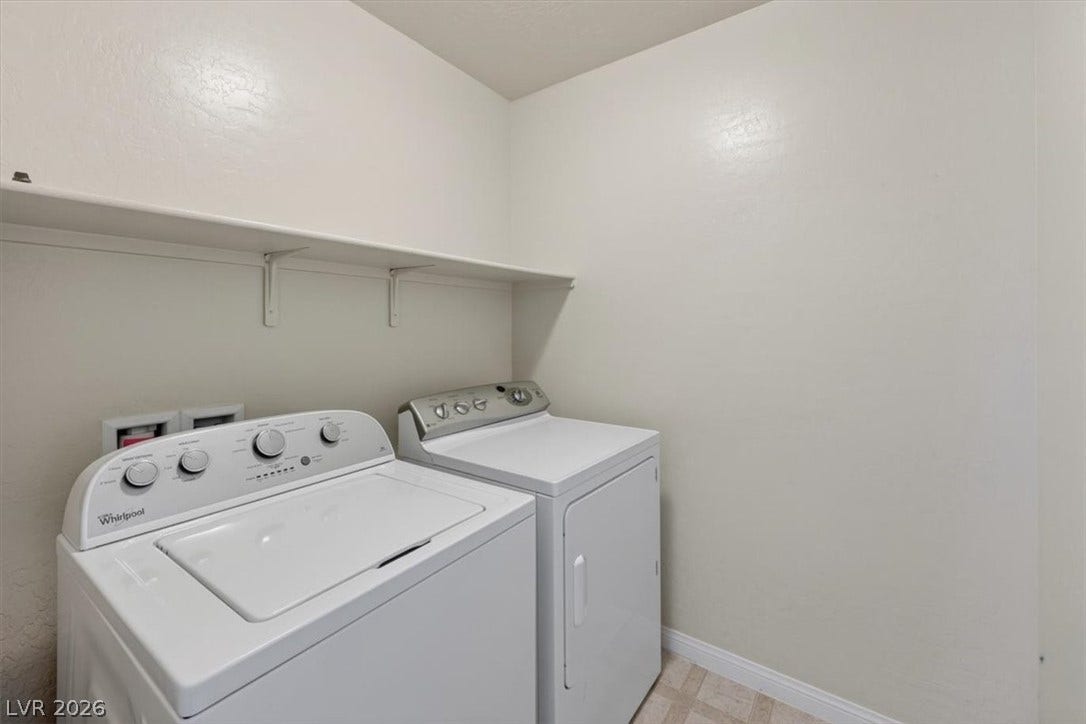1116 Strada Cristallo, Henderson, NV 89011 A well-organized laundry area featuring a washer, dryer, and convenient overhead shelving.