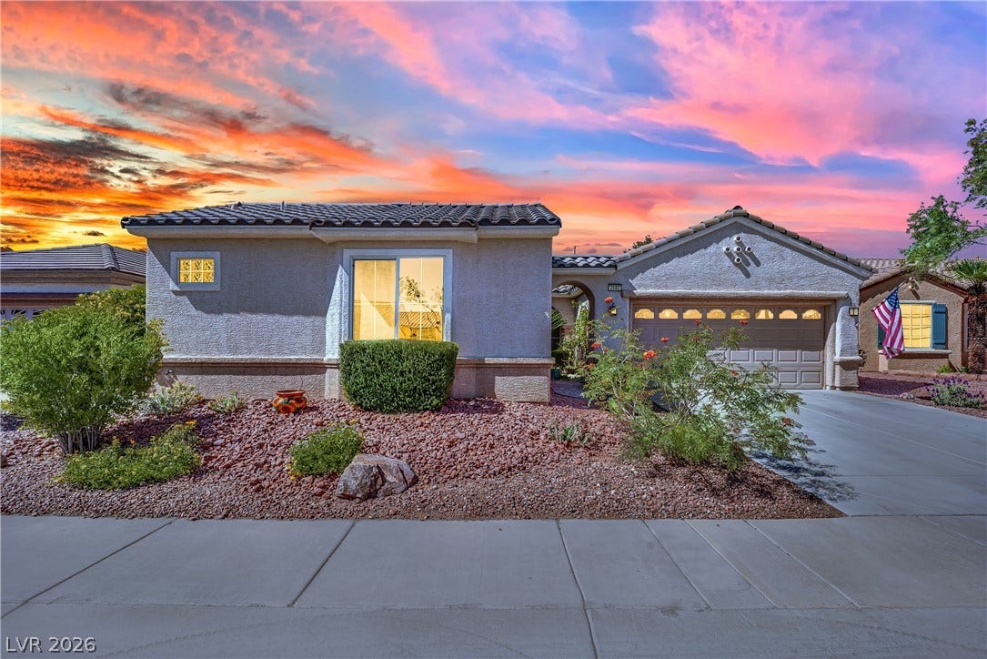 This charming home offers a convenient attached garage, lush front yard landscaping, and a welcoming porch entry.