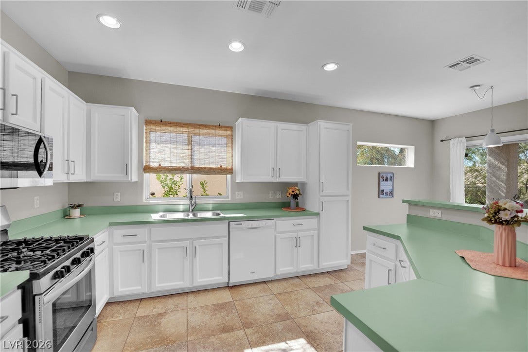 This bright kitchen offers functional design and ample counter space for daily living.