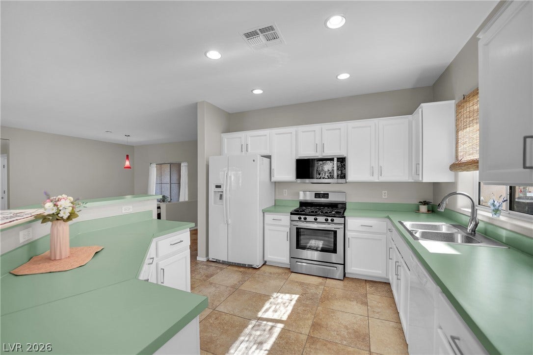 This spacious kitchen offers ample counter space, modern appliances, and convenient open-concept living.