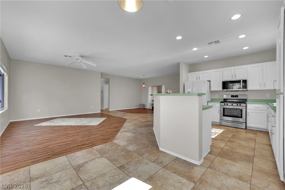 This open concept living space features a modern kitchen and inviting living area.
