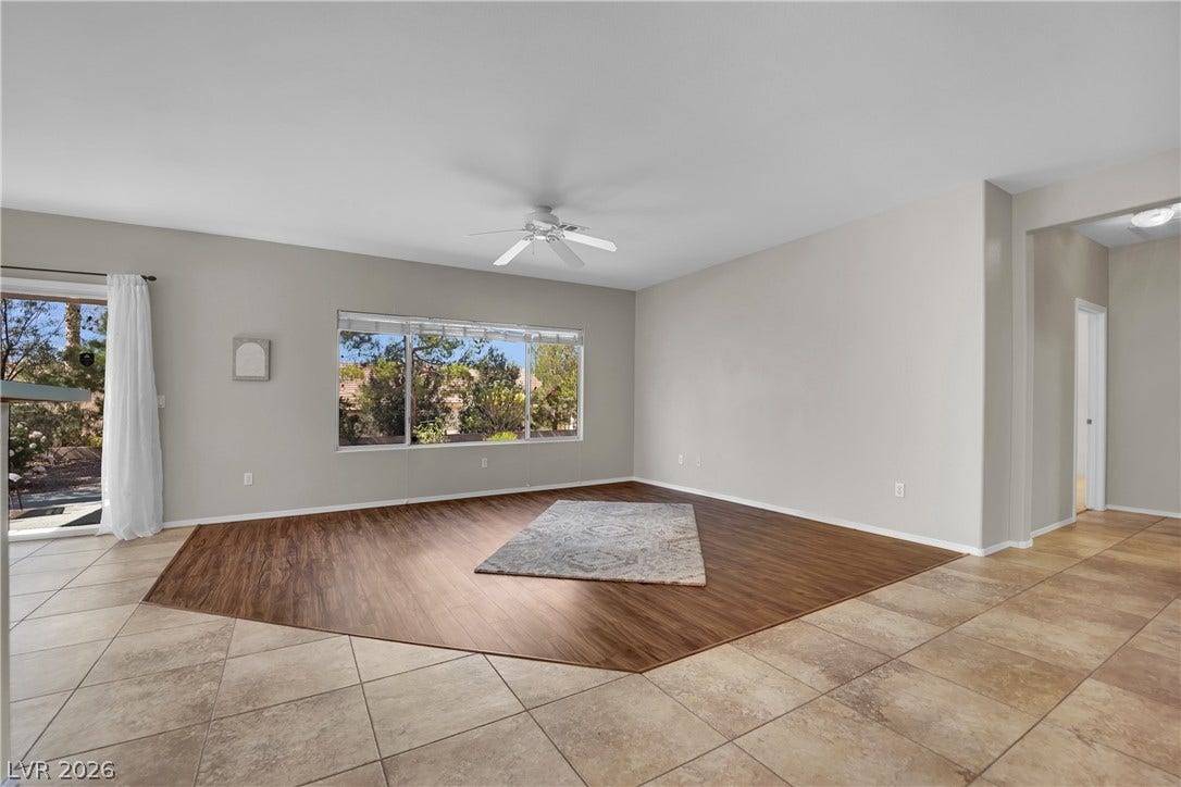 This bright living space features distinct flooring and ample natural light.
