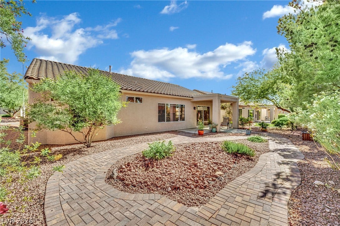This tranquil outdoor space features a well-maintained patio and mature trees.