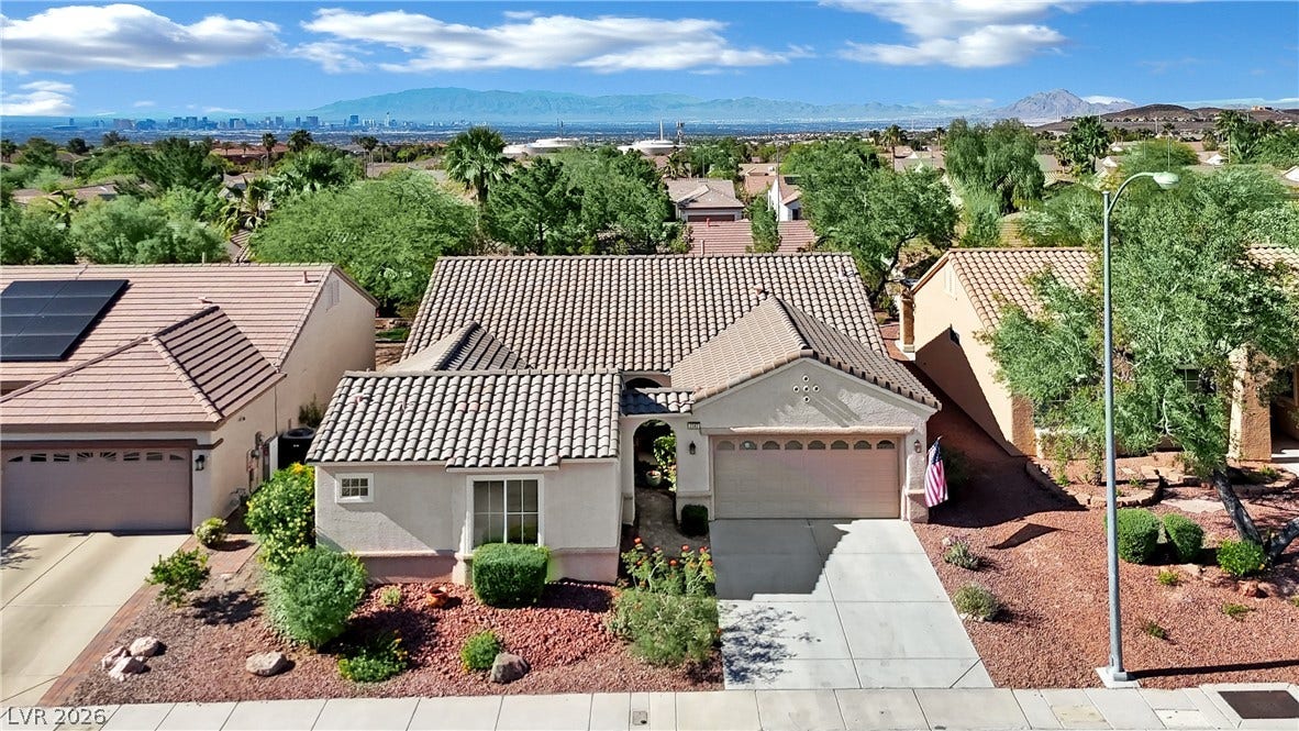 This charming home offers a convenient garage, solar panels, and scenic mountain and city views.