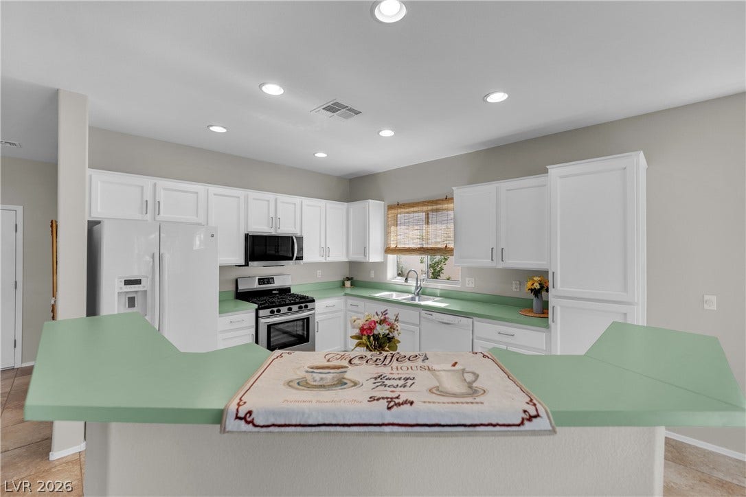 Bright and open kitchen with ample counter space and modern appliances for culinary pursuits.