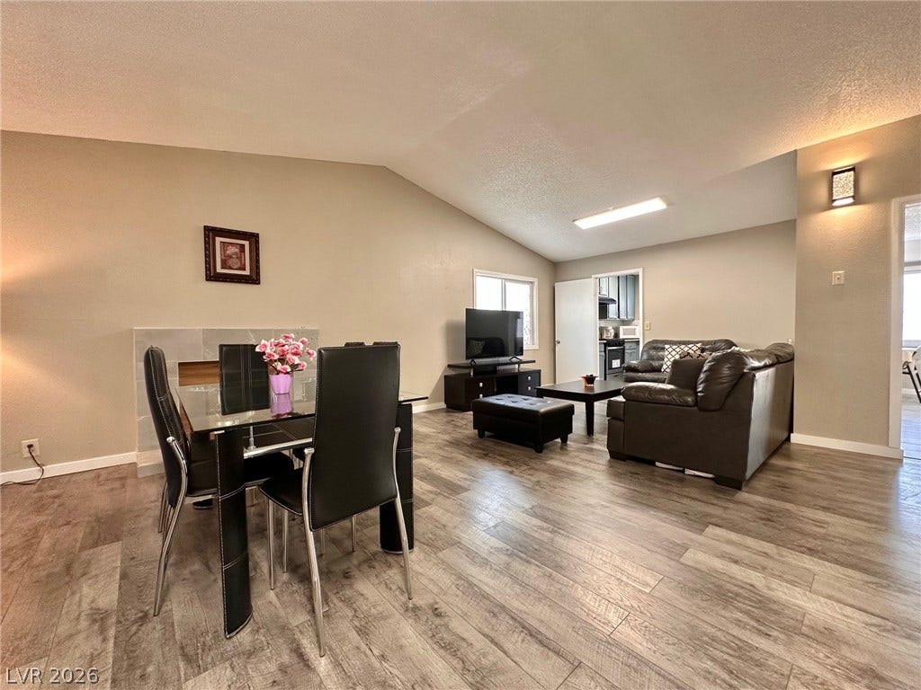 2340 Viewcrest Road, Henderson, NV 89014 This inviting space features a vaulted ceiling and elegant flooring, ideal for comfortable living.