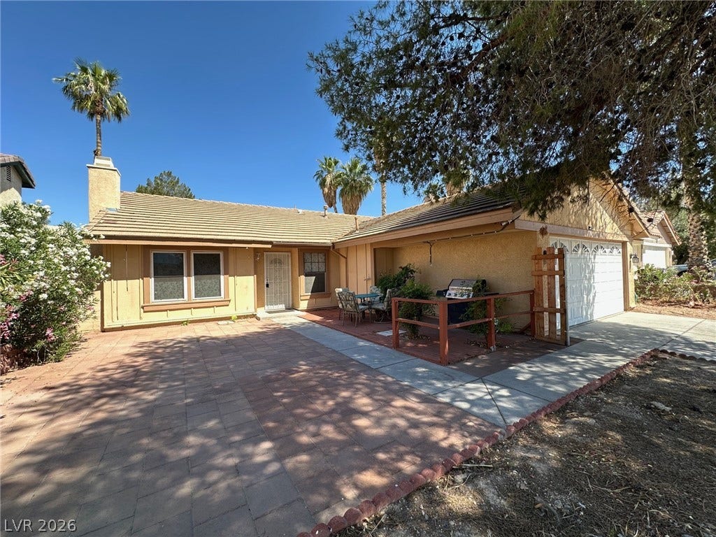 2340 Viewcrest Road, Henderson, NV 89014 This inviting home presents a warm facade with convenient outdoor living space.
