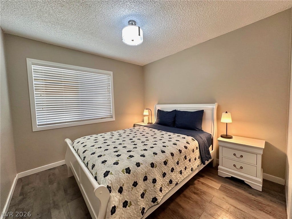 2340 Viewcrest Road, Henderson, NV 89014 This inviting bedroom features rich hardwood flooring and ample natural light.