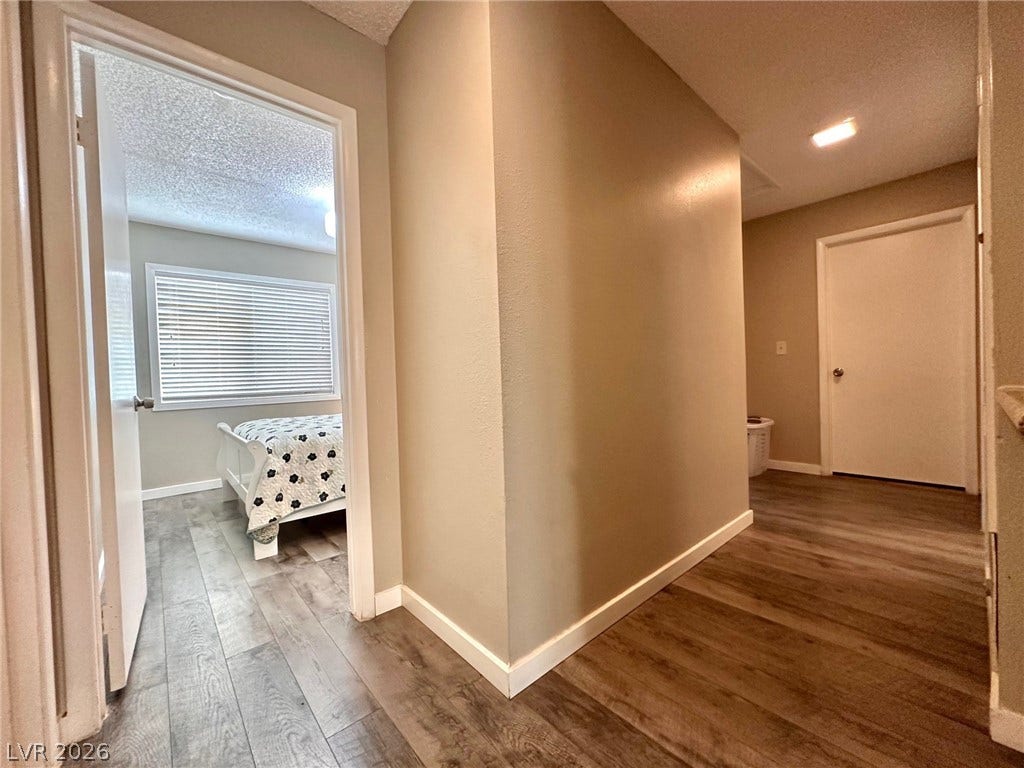 2340 Viewcrest Road, Henderson, NV 89014 This inviting hallway offers a warm welcome, connecting spaces with graceful wood-look flooring.