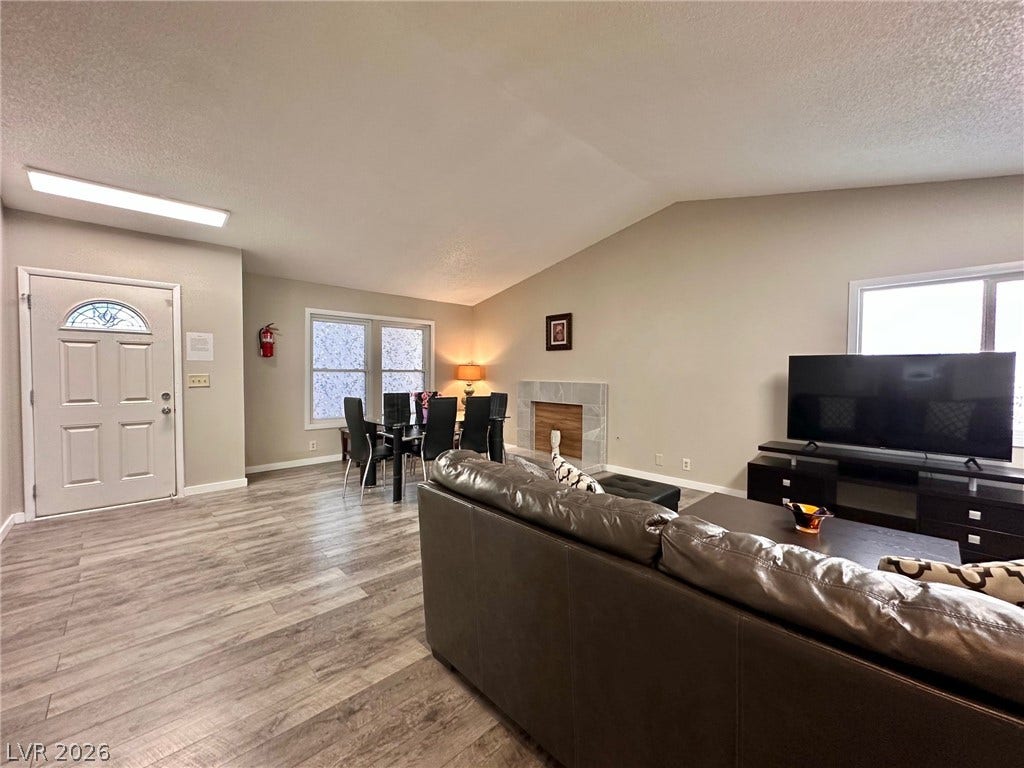 2340 Viewcrest Road, Henderson, NV 89014 This inviting space features an elegant fireplace and durable flooring, perfect for comfortable living.
