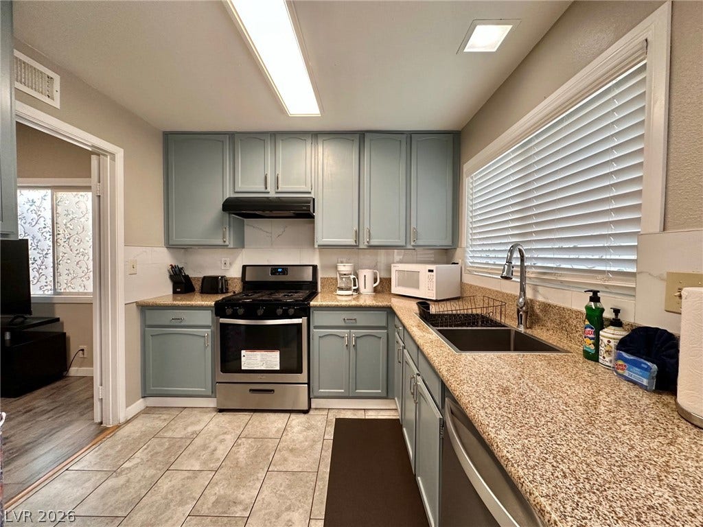 2340 Viewcrest Road, Henderson, NV 89014 This kitchen offers practical design, featuring efficient appliances and a bright window.