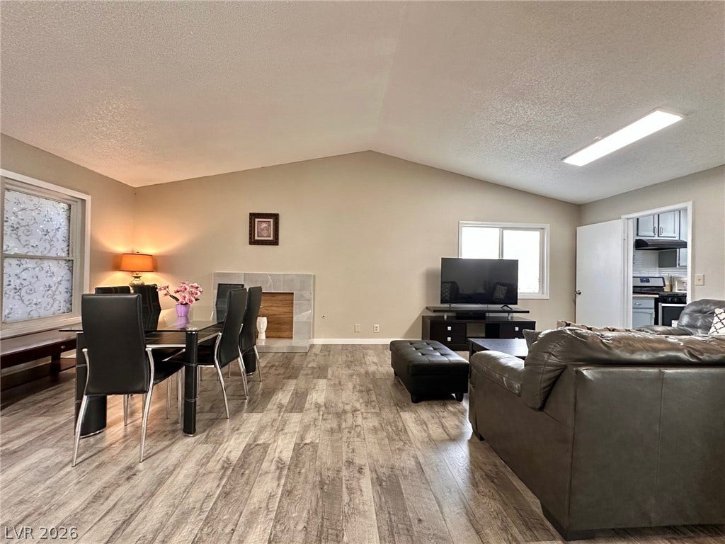 2340 Viewcrest Road, Henderson, NV 89014 This versatile living space features vaulted ceilings, inviting both relaxation and intimate dining experiences.