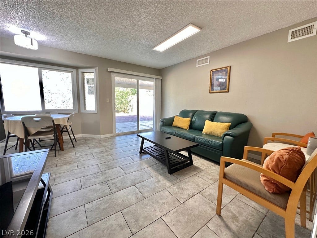2340 Viewcrest Road, Henderson, NV 89014 This living space offers a seamless transition to the outdoors through sliding doors.