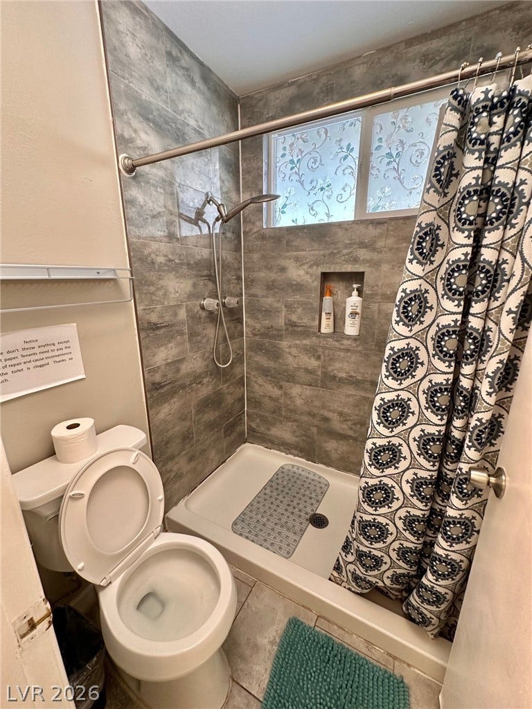 2340 Viewcrest Road, Henderson, NV 89014 This clean and functional bathroom features a shower with tiled walls and a window.