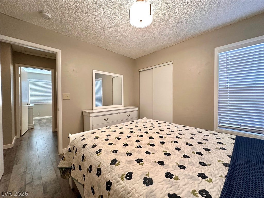 2340 Viewcrest Road, Henderson, NV 89014 This cozy bedroom features durable wood flooring and ample natural light through its window.