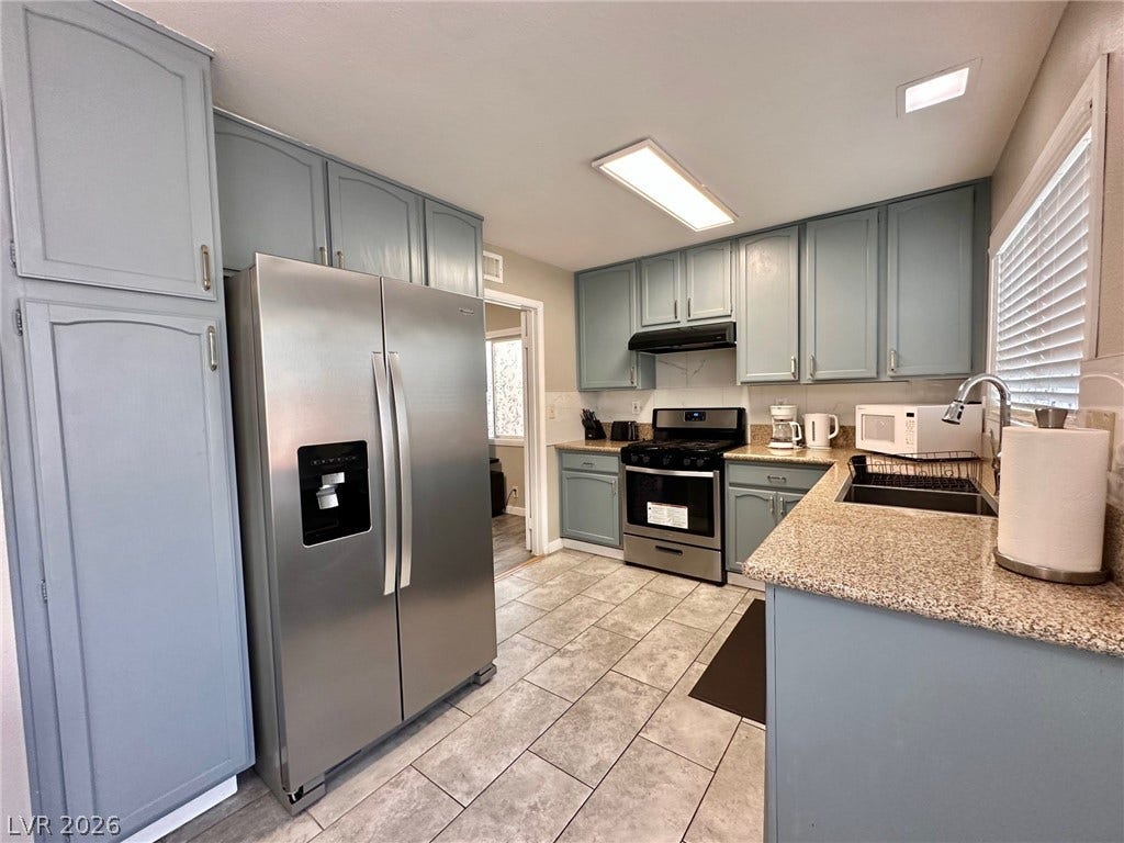 2340 Viewcrest Road, Henderson, NV 89014 This bright kitchen features durable tile flooring, ample cabinetry, and sleek stainless steel appliances.