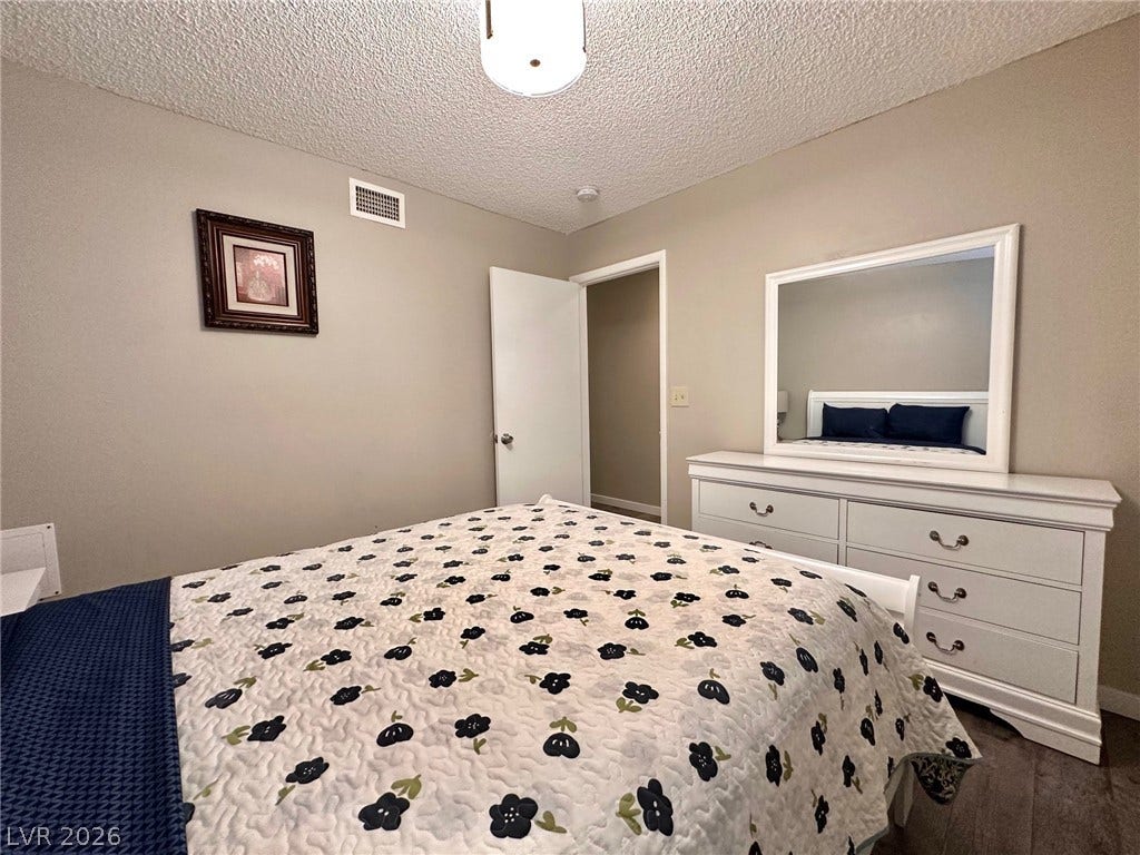 2340 Viewcrest Road, Henderson, NV 89014 This cozy bedroom features durable flooring and a neutral color palette, ideal for peaceful rest.