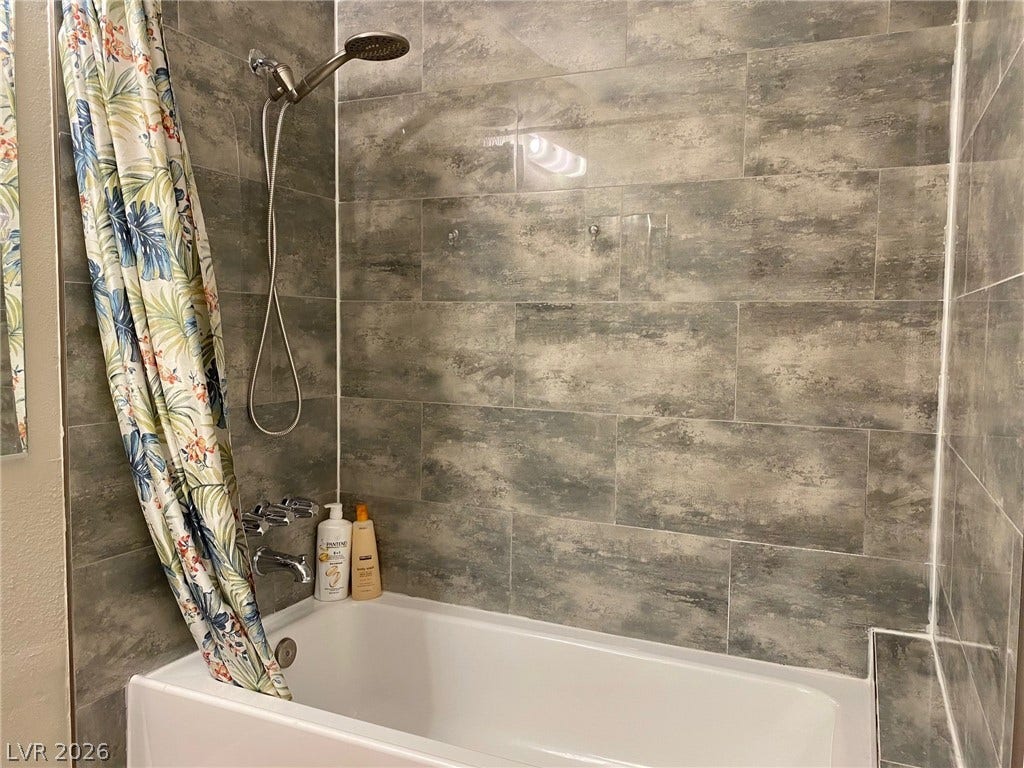 2340 Viewcrest Road, Henderson, NV 89014 This clean bathroom features modern tile work and a convenient shower-over-tub design.