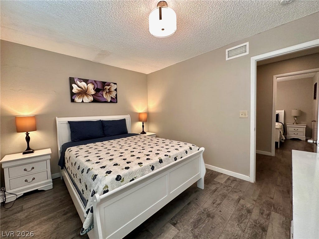 2340 Viewcrest Road, Henderson, NV 89014 This cozy bedroom offers comfort and a tranquil escape.
