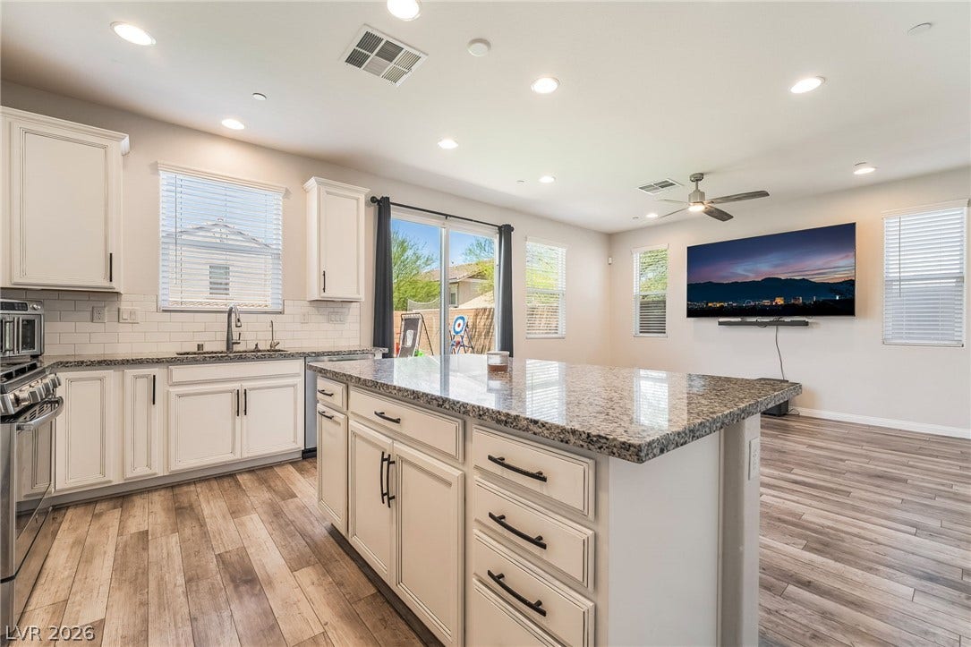 360 Misterioso Street, Henderson, NV 89011 This bright kitchen features a spacious island and seamless flow to the living area.