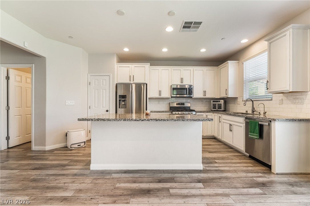 360 Misterioso Street, Henderson, NV 89011 This bright and airy kitchen boasts ample counter space and modern appliances, perfect for culinary adventures.