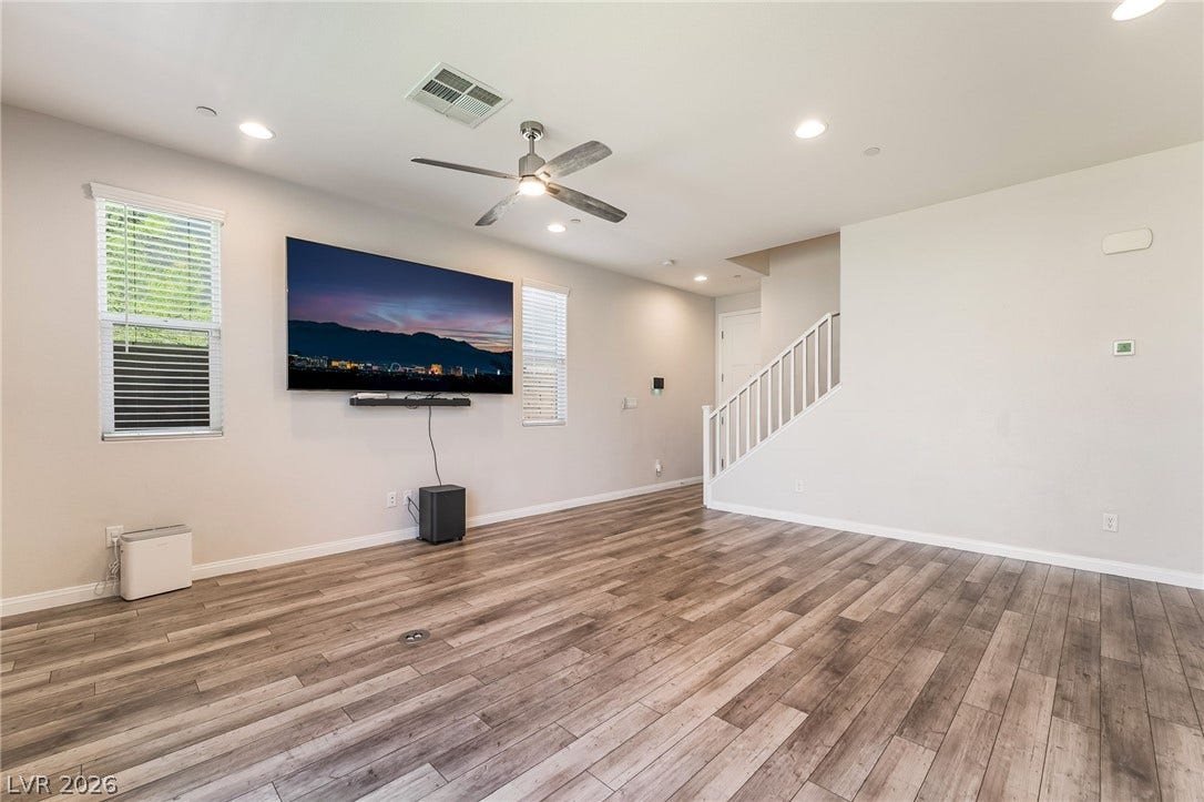 360 Misterioso Street, Henderson, NV 89011 This inviting living area boasts rich hardwood flooring and abundant natural light.