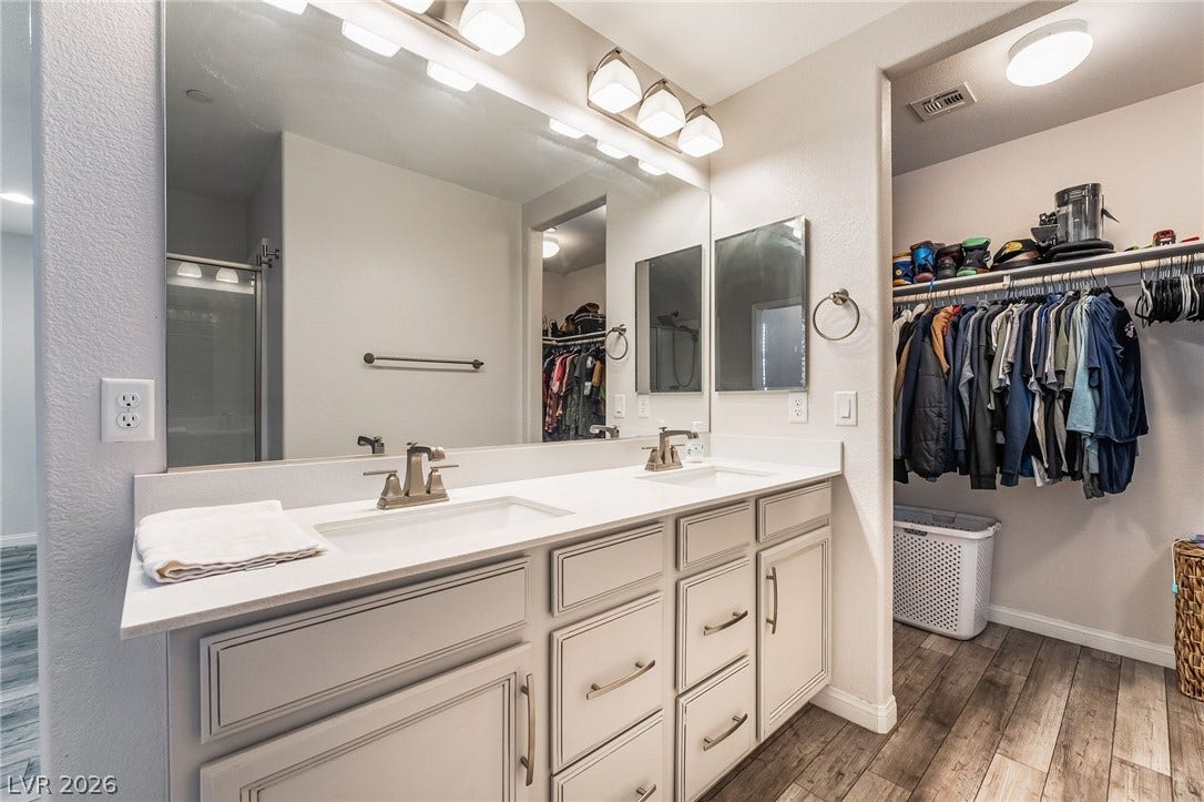 360 Misterioso Street, Henderson, NV 89011 This primary bathroom features a double vanity and a spacious walk-in closet.