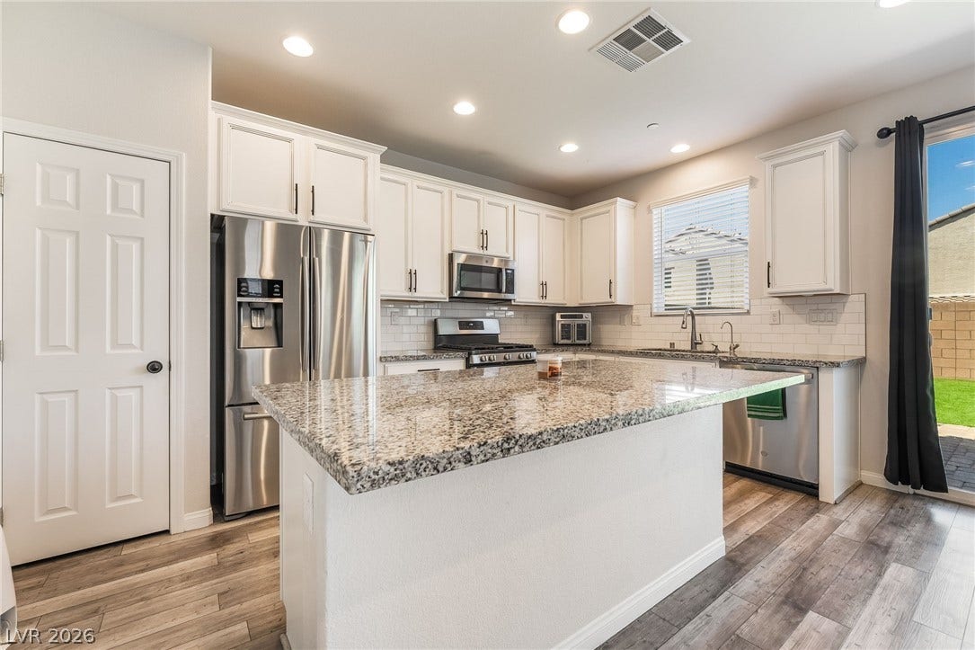 360 Misterioso Street, Henderson, NV 89011 This bright and open kitchen features ample counter space and modern appliances.
