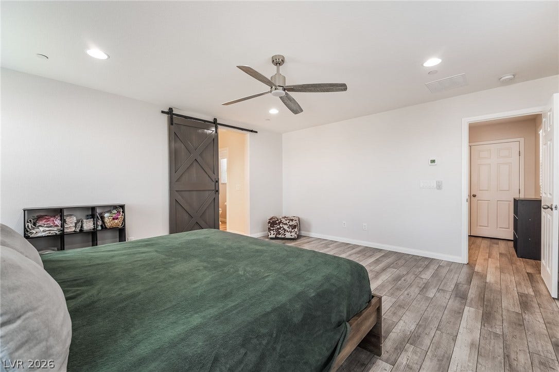 360 Misterioso Street, Henderson, NV 89011 This serene bedroom offers a tranquil retreat with ample space and modern touches.