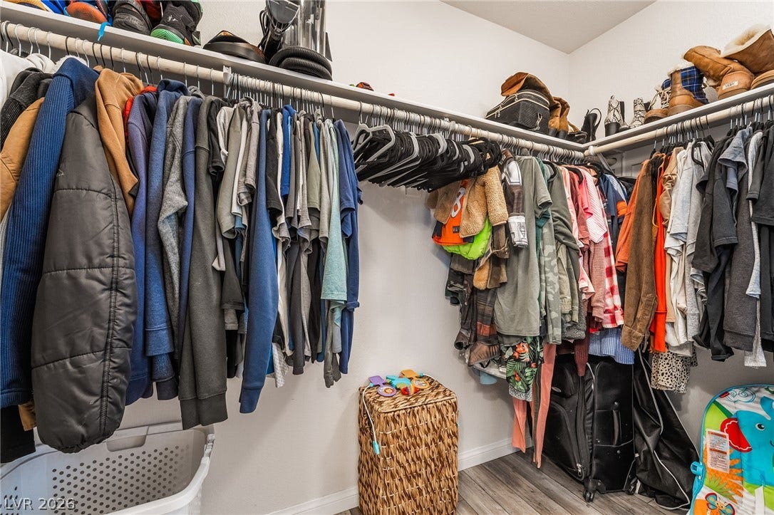 360 Misterioso Street, Henderson, NV 89011 This spacious walk-in closet offers abundant storage and organized hanging space for your wardrobe.