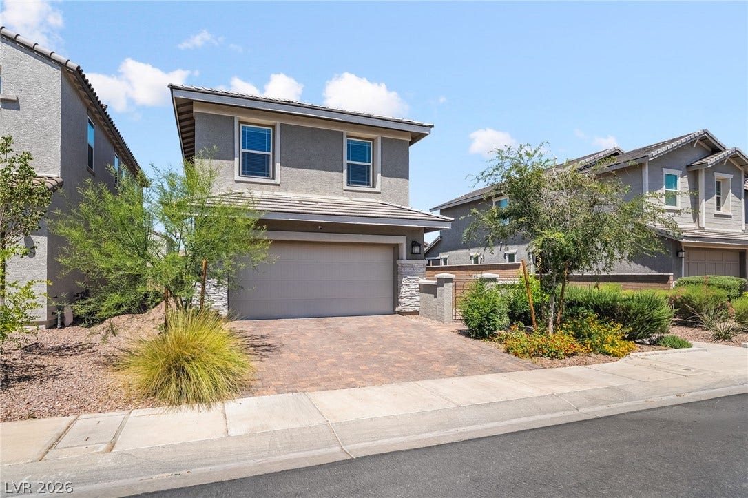 360 Misterioso Street, Henderson, NV 89011 This residence showcases a paved driveway and mature landscaping, presenting a welcoming facade.