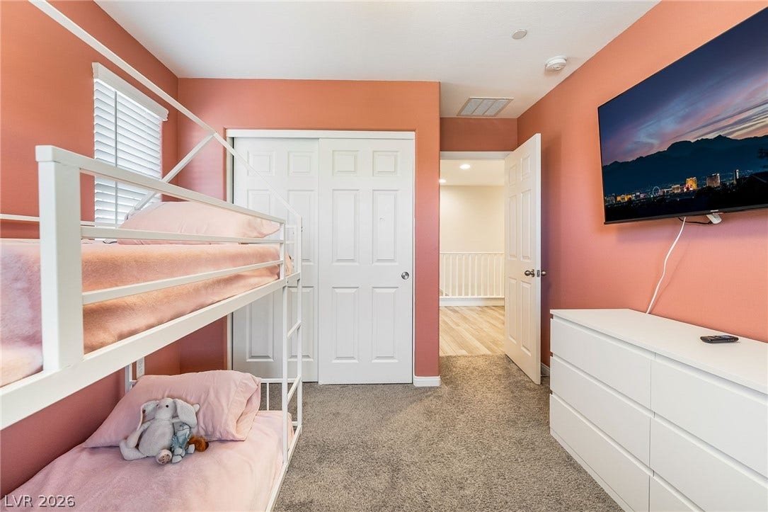 360 Misterioso Street, Henderson, NV 89011 This cozy bedroom features a practical bunk bed, ample storage, and easy access to an adjacent hallway.