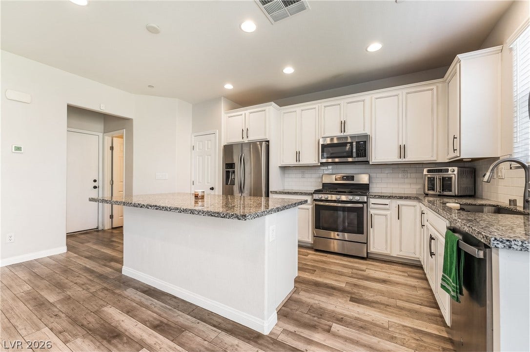 360 Misterioso Street, Henderson, NV 89011 This bright kitchen features durable flooring and ample counter space for all your culinary endeavors.