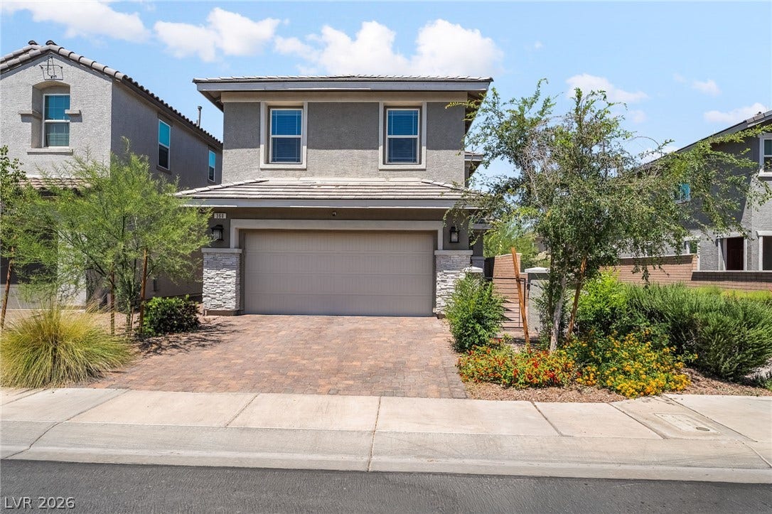 360 Misterioso Street, Henderson, NV 89011 This two-story home features a tiled roof, paver driveway, and well-maintained landscaping, creating an inviting curb appeal.