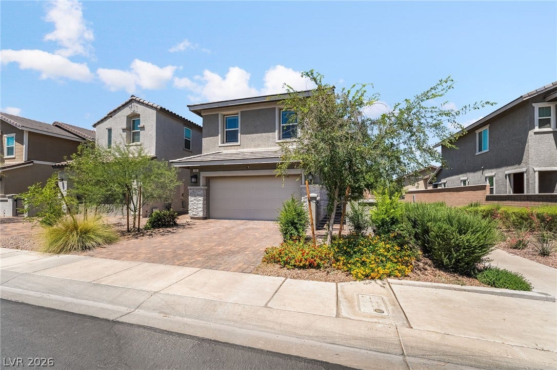 360 Misterioso Street, Henderson, NV 89011 This residence features a paver driveway and a well-maintained front yard.