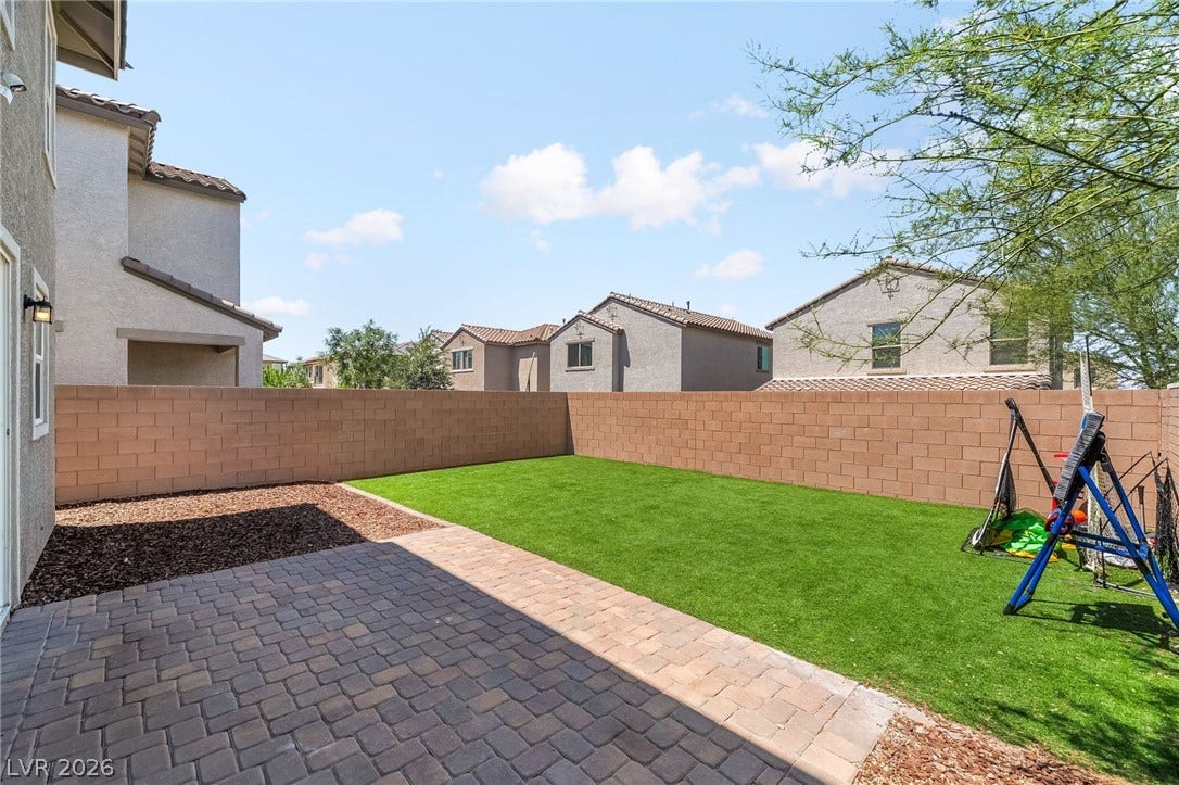 360 Misterioso Street, Henderson, NV 89011 Enjoy outdoor living with a manicured lawn and a spacious paver patio.